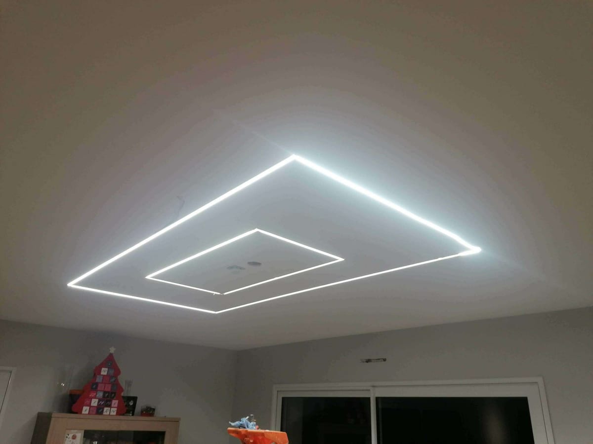 Profilés d'éclairage LED encastrés au plafond d'une pièce à vivre